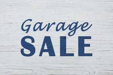 Image of Words Garage Sale on white wooden surface, top view