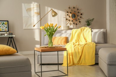 Photo of Stylish living room with sofa. Interior design in grey and yellow colors