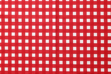 Red checkered tablecloth as background, top view