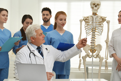 Professional orthopedist teaching medical students in clinic