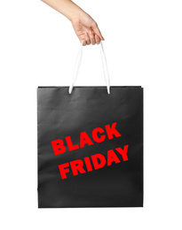 Woman holding paper shopping bag with phrase BLACK FRIDAY on white background