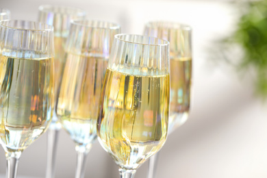 Photo of Glasses of champagne on blurred background, closeup view