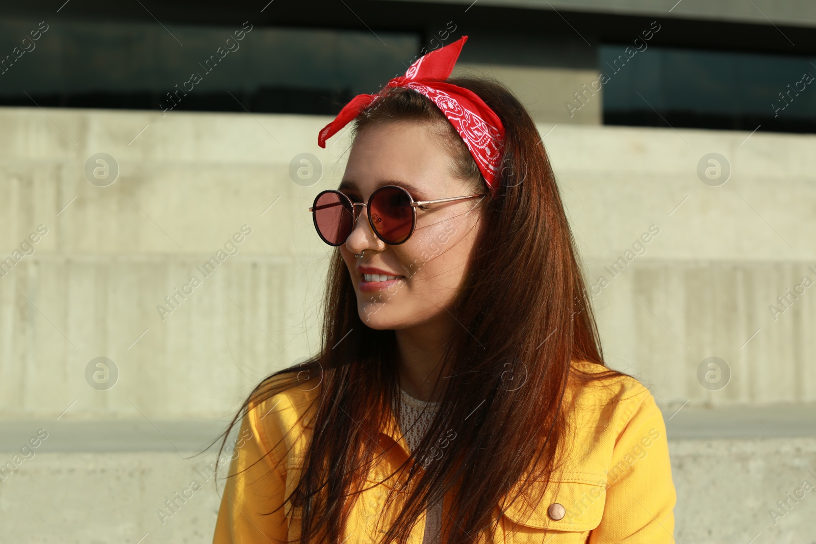 Photo of Beautiful young woman with nose piercing outdoors