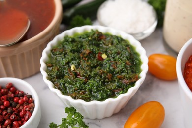 Photo of Fresh homemade marinade in bowl on table, closeup