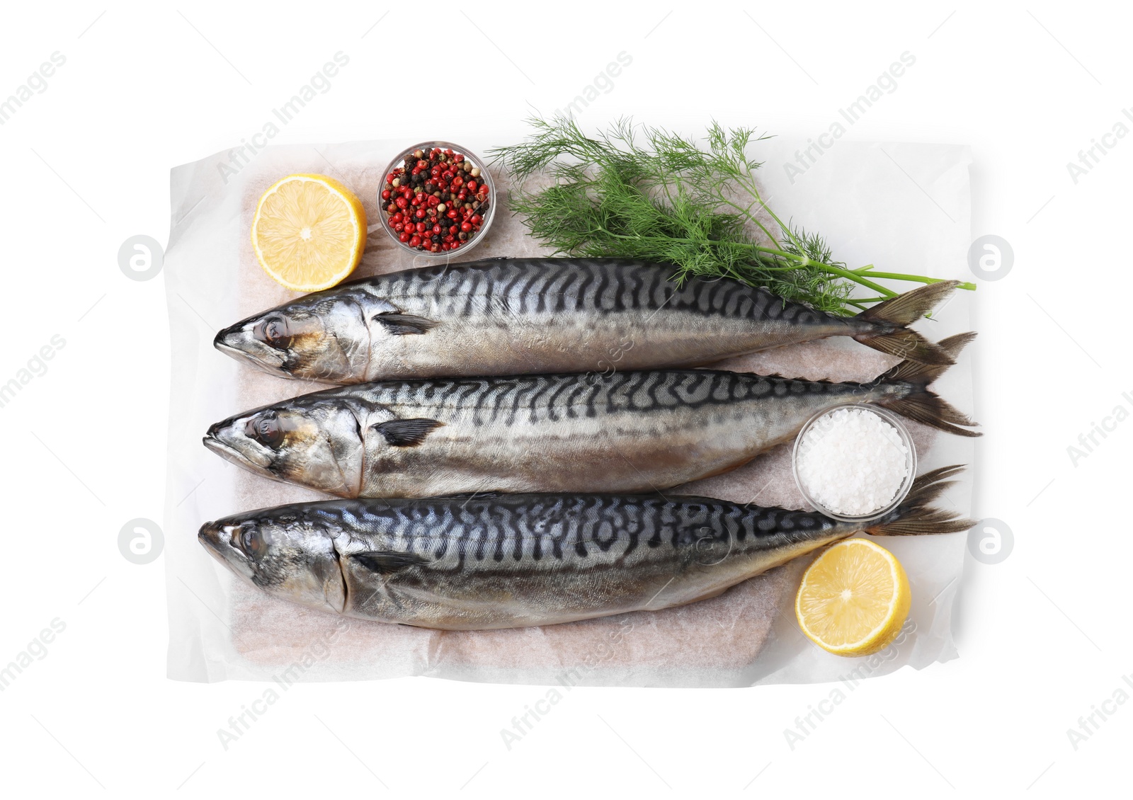 Photo of Tasty salted mackerels, spices and cut lemons on white background, top view