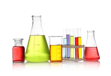 Set of lab glassware with color liquids isolated on white. Solution chemistry