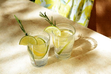 Glasses of tasty refreshing lemonade on light table. Summer drink
