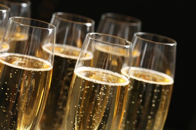 Glasses of champagne on dark background, closeup