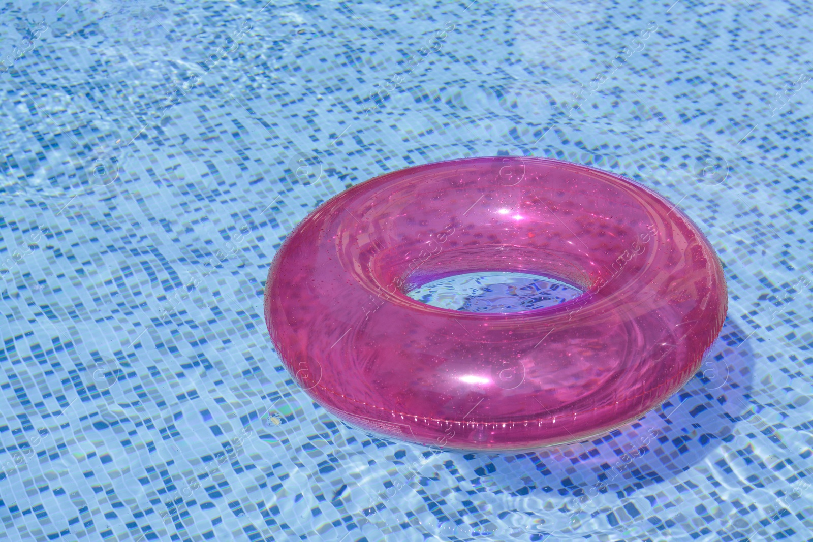 Photo of Inflatable ring floating on water in swimming pool