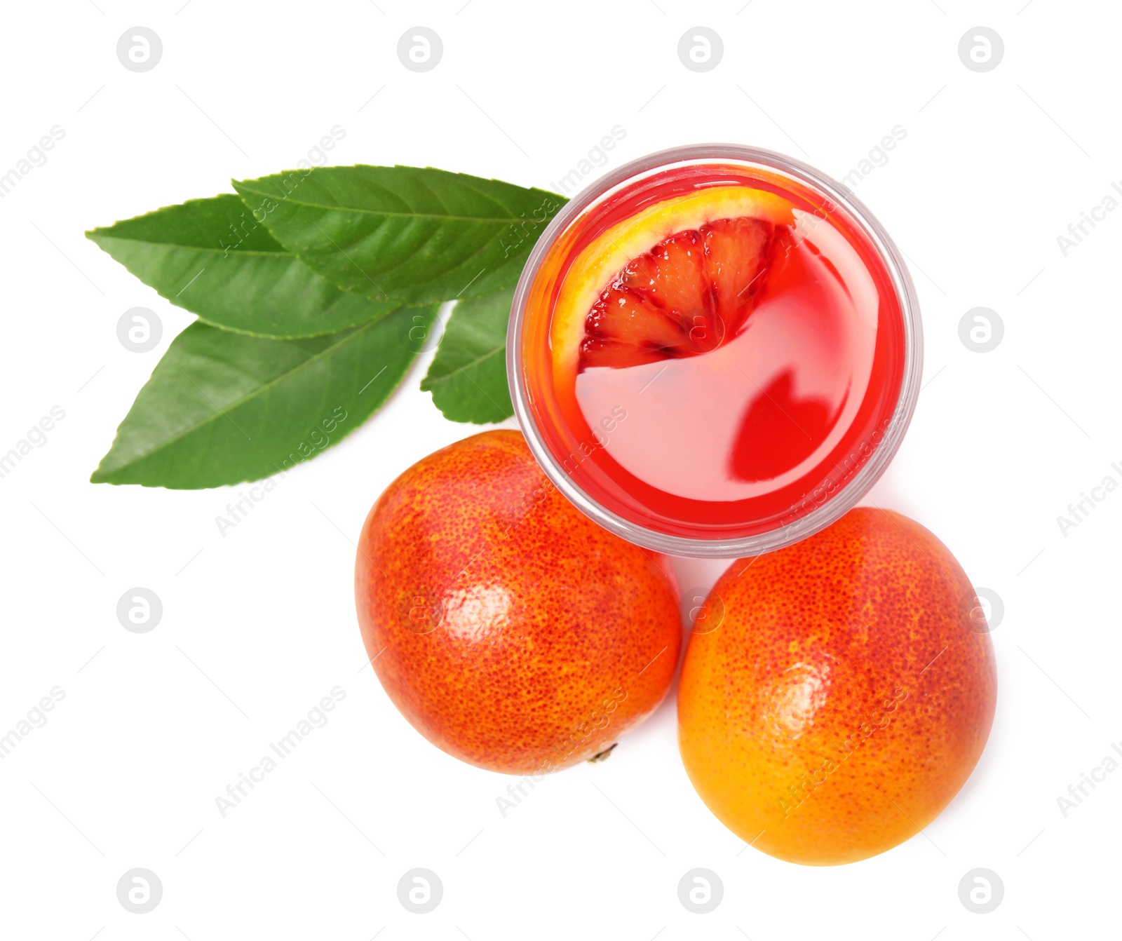 Photo of Tasty sicilian orange juice in glass, fruits and leaves on white background, top view