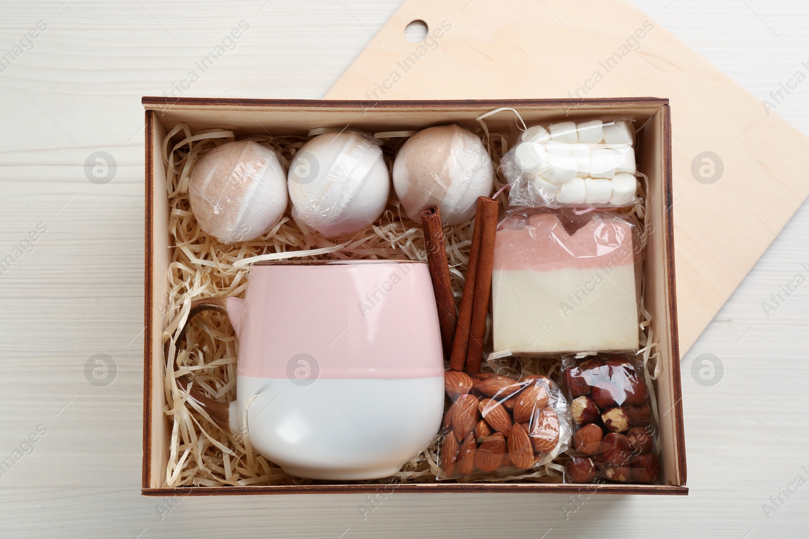 Photo of Stylish gift set on white wooden table, flat lay