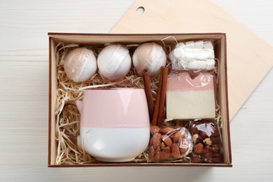 Stylish gift set on white wooden table, flat lay