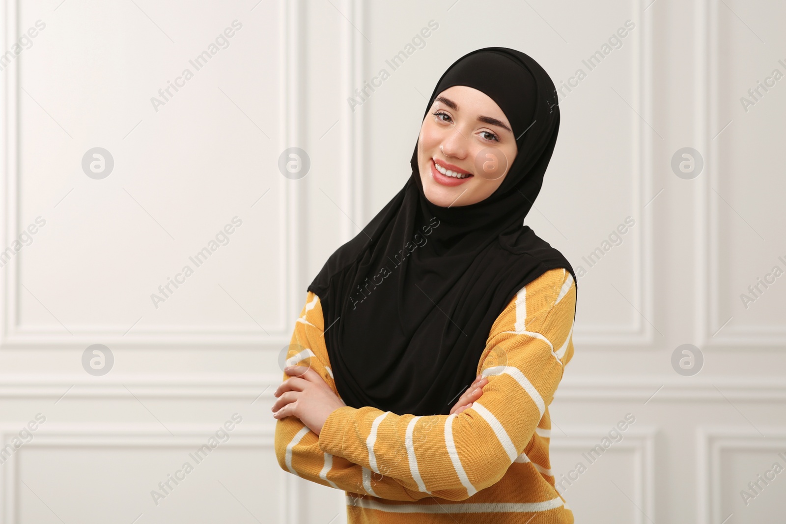 Photo of Portrait of Muslim woman in hijab indoors, space for text