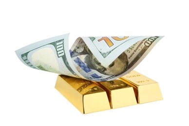 Shiny gold bars and dollar bill on white background