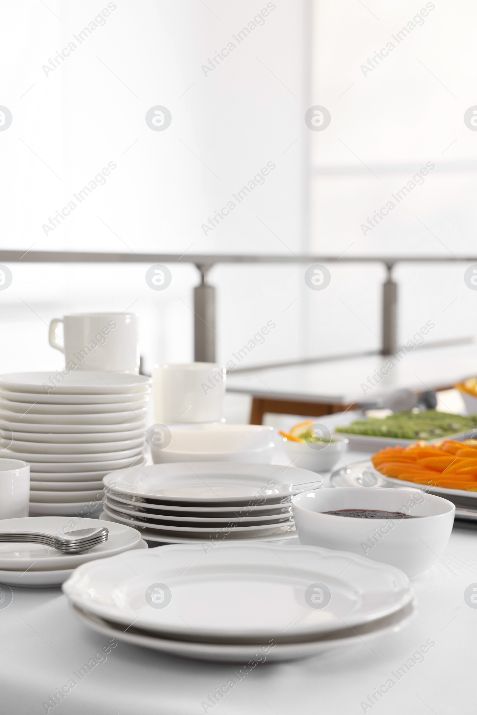 Photo of Clean dishware and different meals for breakfast on white table indoors. Buffet service