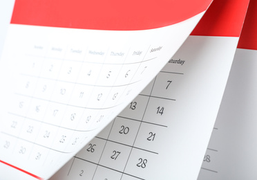 Photo of Paper calendar with turning pages as background, closeup
