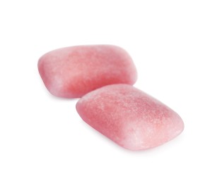 Photo of Tasty sweet chewing gums on white background