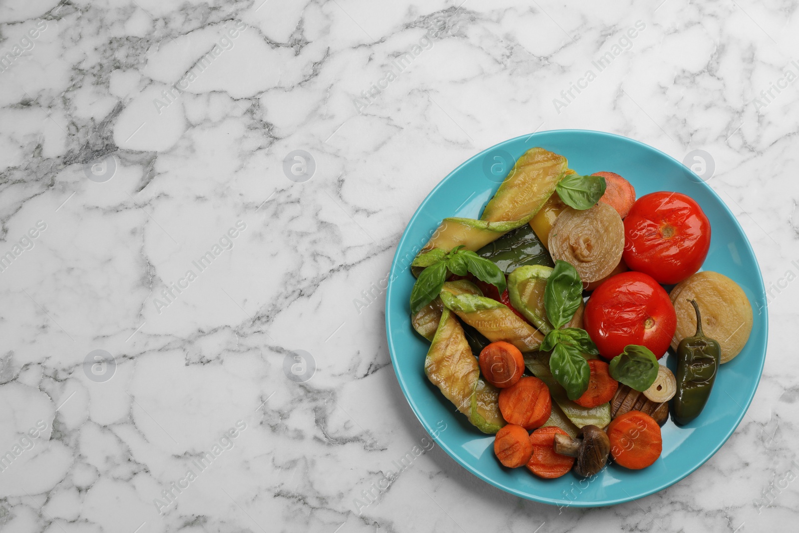 Photo of Delicious grilled vegetables on white marble table, top view. Space for text