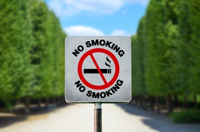 Image of Sign No Smoking in park on sunny day