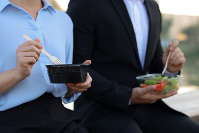 Photo of Business people having lunch together outdoors, closeup
