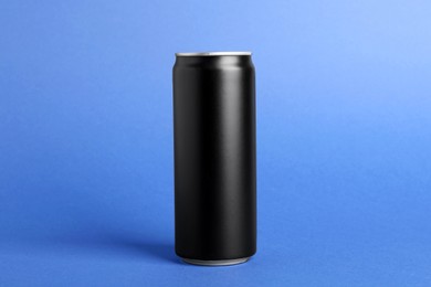 Photo of Energy drink in black can on blue background