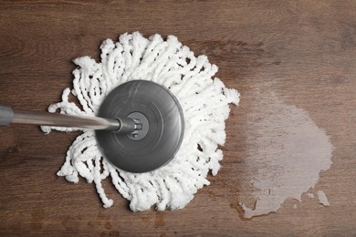 Photo of Cleaning parquet floor with mop, top view