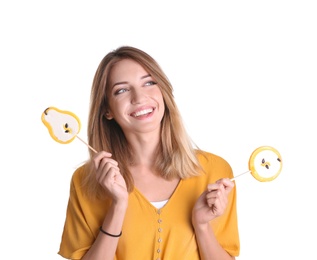 Young pretty woman with candies on white background