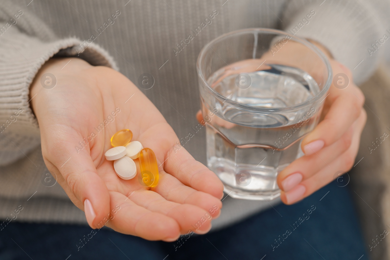 Photo of Woman with glass of water and pills, closeup view