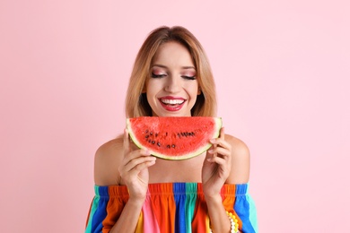 Photo of Pretty young woman with juicy watermelon on color background