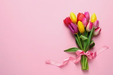 Photo of Beautiful bouquet of spring tulip flowers on color background, top view. Space for text