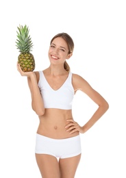 Photo of Happy slim woman in underwear holding pineapple on white background. Weight loss diet