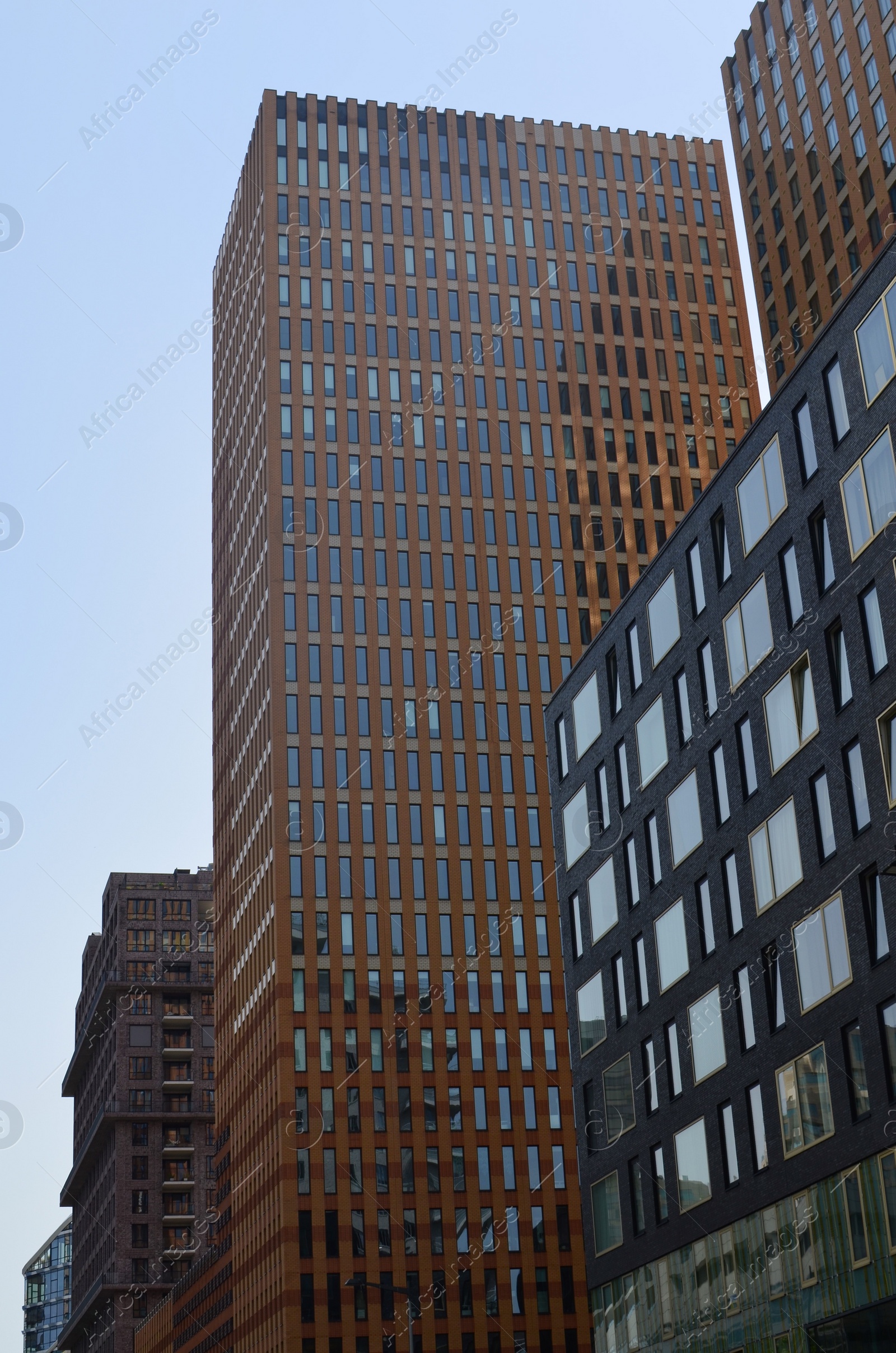 Photo of Exterior of beautiful modern skyscrapers against blue sky