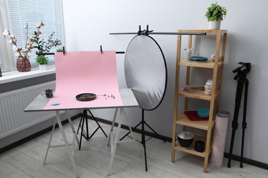 Photo of Professional equipment and composition with delicious dessert on pink background in studio. Food photography