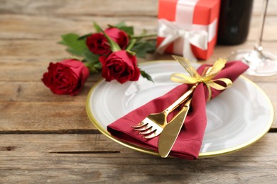 Photo of Beautiful table setting for Valentine's Day dinner on wooden background, closeup