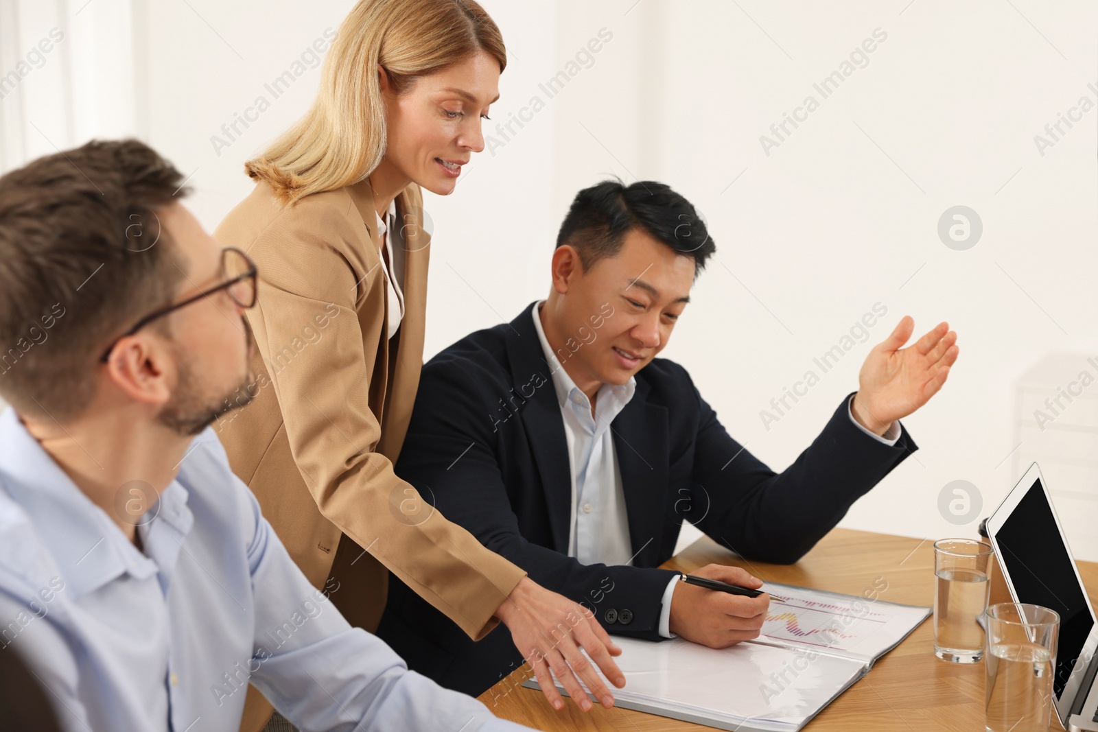 Photo of Businesswoman having meeting with her employees in office