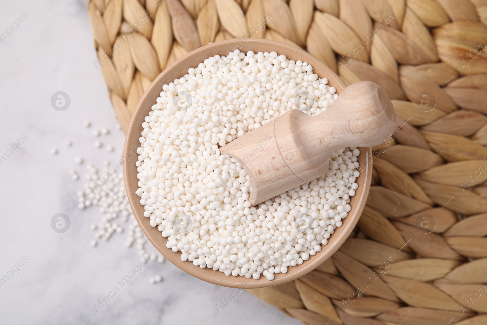 Photo of Tapioca pearls in bowl on white table, top view