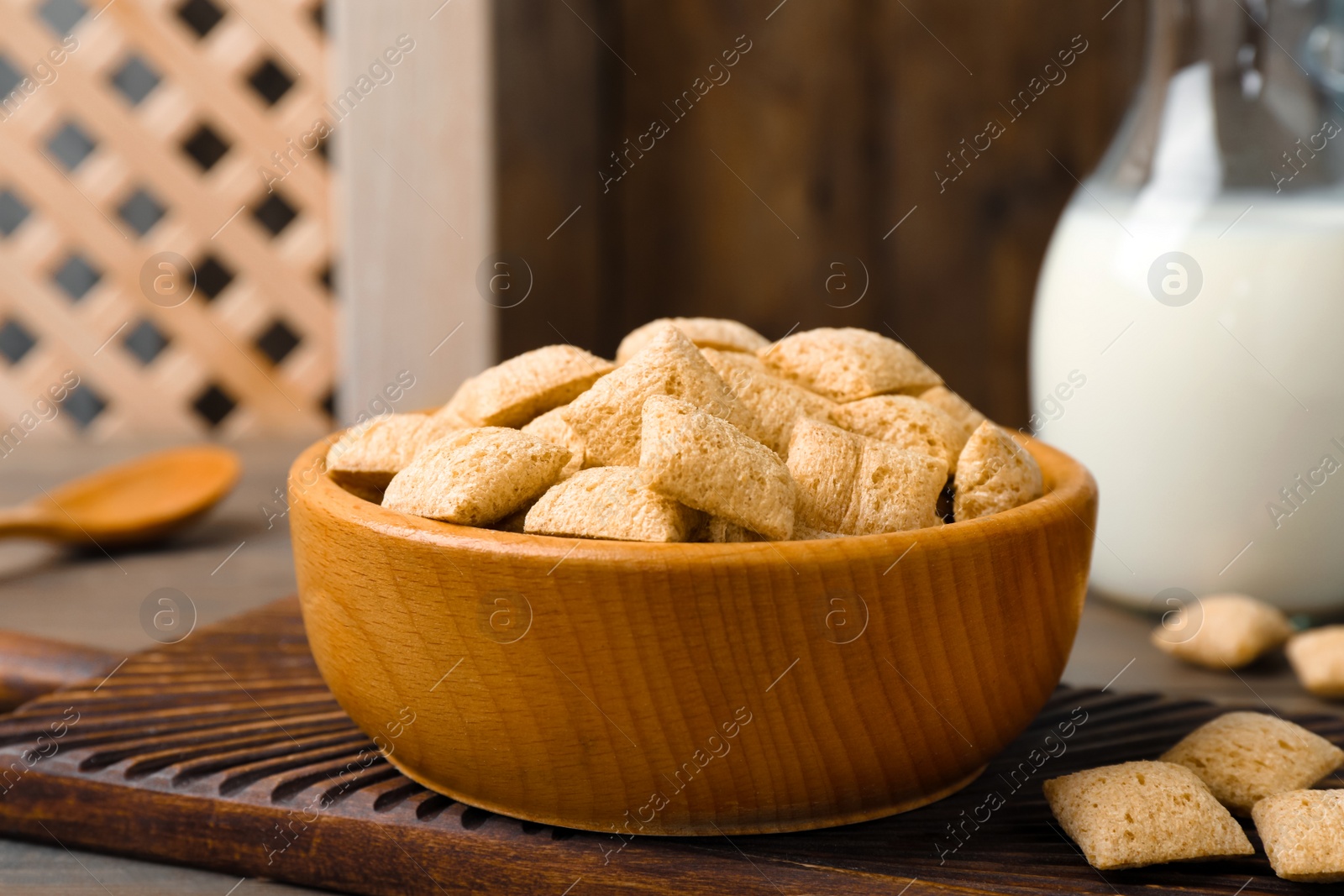 Photo of Bowl of delicious corn pads on wooden table