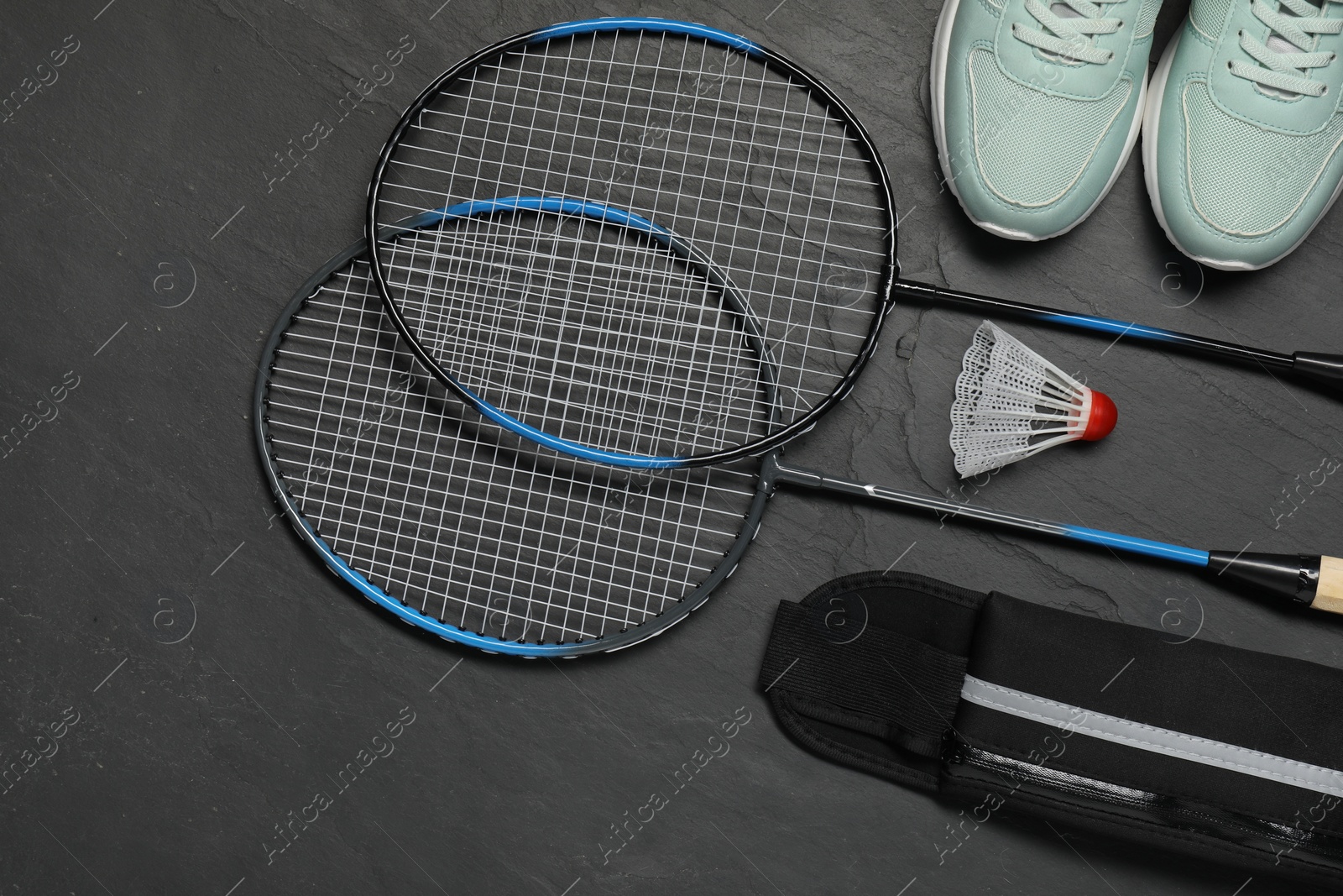 Photo of Different sports equipment on black table, flat lay