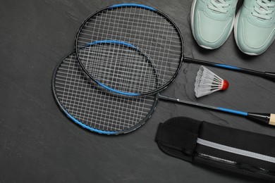 Different sports equipment on black table, flat lay