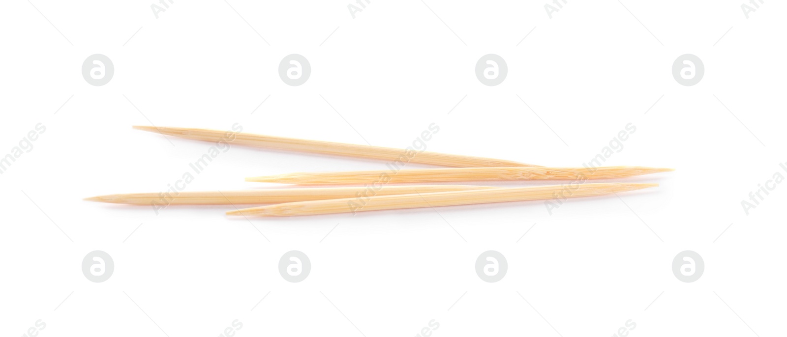 Photo of Four disposable wooden toothpicks on white background