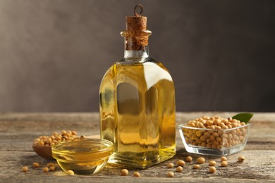 Photo of Composition with soybean oil on wooden table