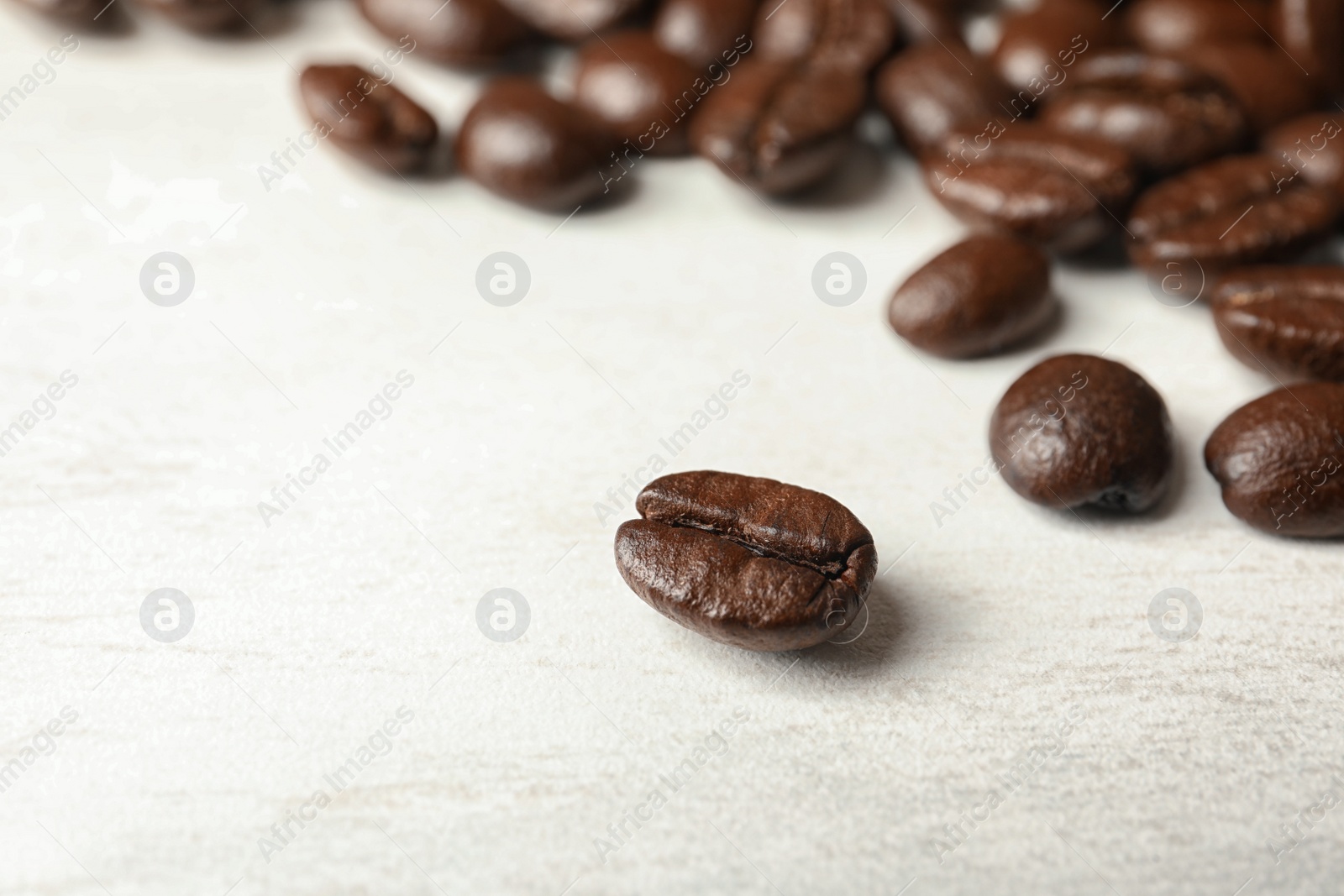 Photo of Roasted coffee beans on white background, closeup