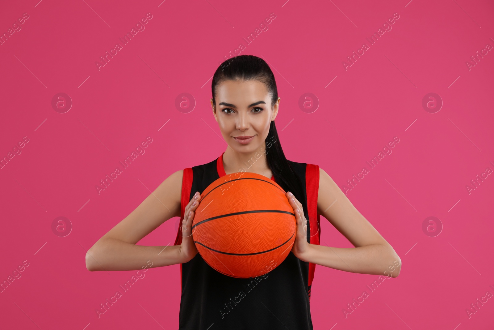 Photo of Basketball player with ball on pink background