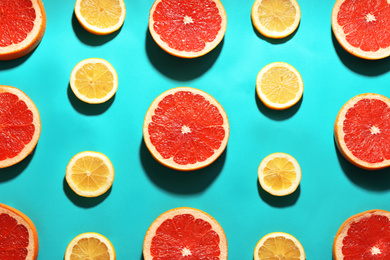 Flat lay composition with tasty ripe grapefruit slices on blue background