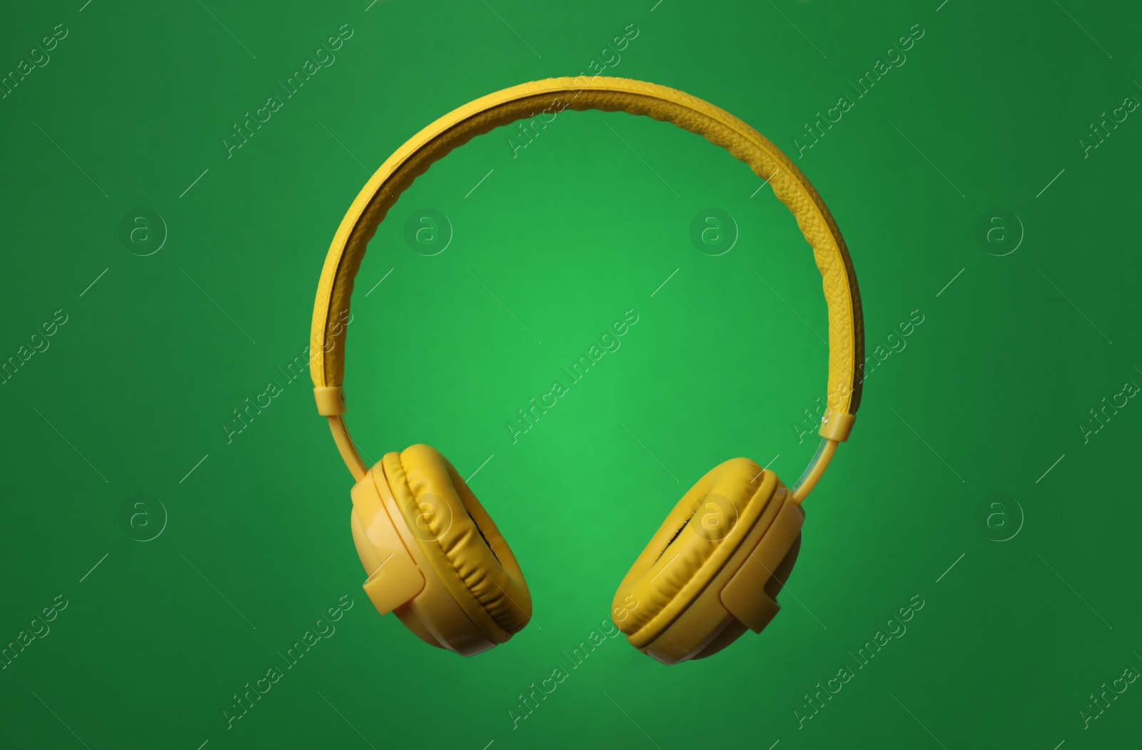 Photo of Stylish modern headphones with earmuffs on color background