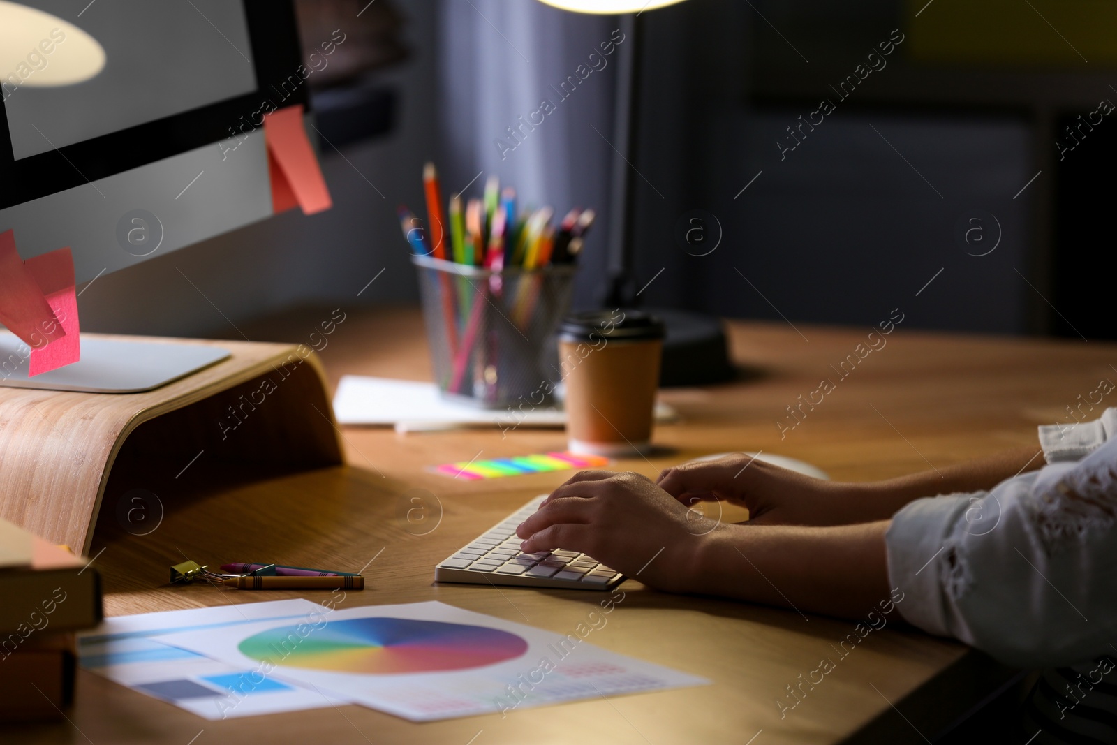 Photo of Female designer working at desk in office, closeup