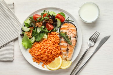 Photo of Plate with healthy food high in vegetable fats served on light wooden table, flat lay