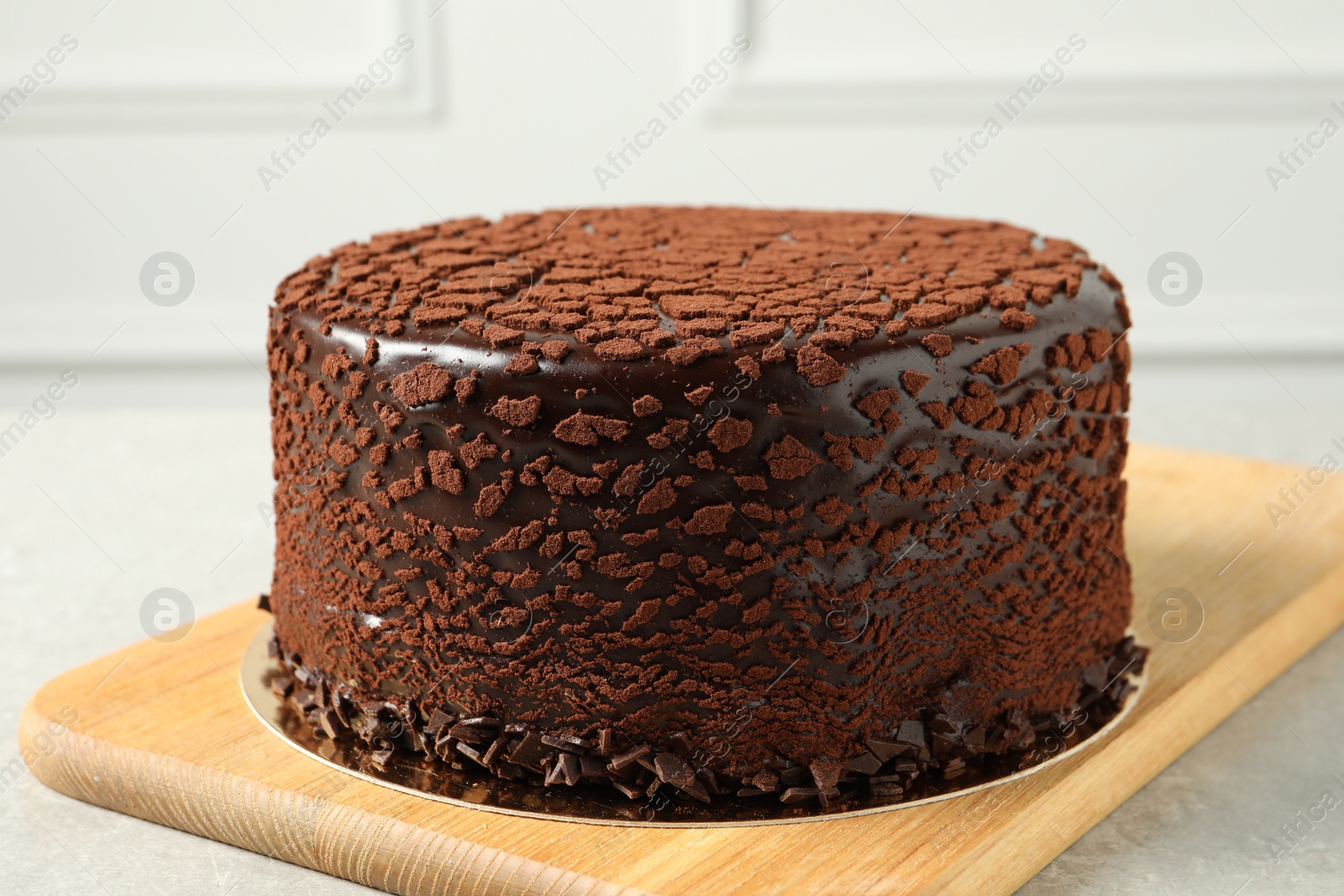 Photo of Delicious chocolate truffle cake on light grey table