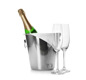 Bottle of champagne in bucket and glasses on white background