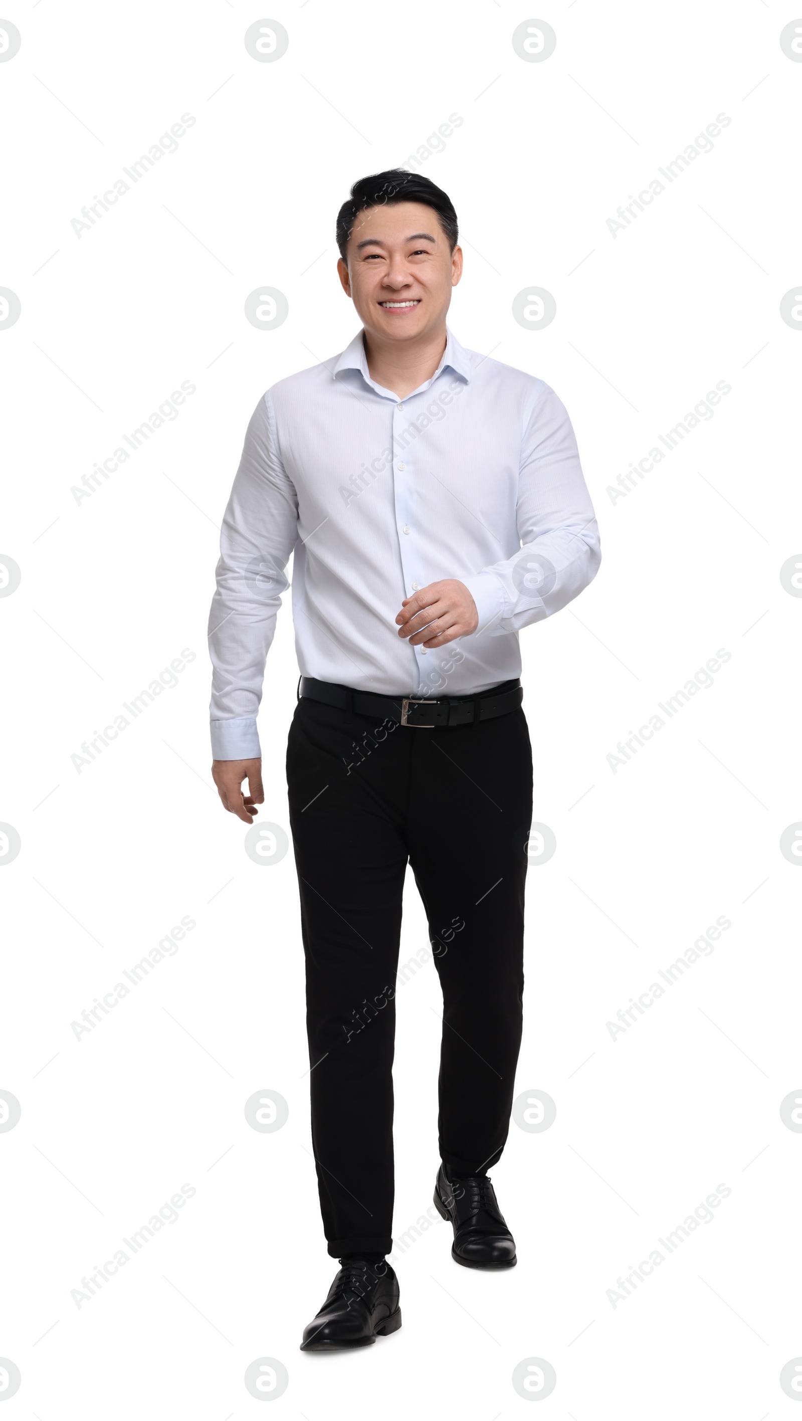 Photo of Businessman in formal clothes walking on white background